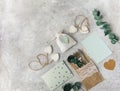 Flat lay wedding composition with card, decorations and eucalyptus, greetings, invitation