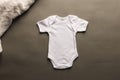 Flat lay of white baby grow with copy space on grey background