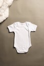 Flat lay of white baby grow with copy space on grey background