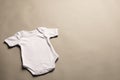 Flat lay of white baby grow with copy space on grey background