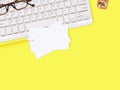 Flat lay white business card over keyboard with glasses, pencil, and cactus on yellow office desktop with copy space for text. Royalty Free Stock Photo