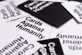 Flat lay of a white cards against humanity card with other cards framing it in the middle, angled view with shall depth of field Royalty Free Stock Photo