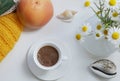 Flat lay, white cup of coffee and orange grapefruit and white daisy flowers on a white background with design elements Royalty Free Stock Photo