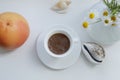 Flat lay, white cup of coffee and orange grapefruit and white daisy flowers on a white background with design elements Royalty Free Stock Photo