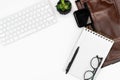 Flat-lay of White office desk. keyboard, glasses, coffee, notebook and laptop case. copy space layout Royalty Free Stock Photo