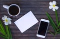 Flat lay with white paper and bamboo leaves on wooden background. Royalty Free Stock Photo