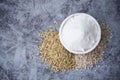 Flat lay of White rice flour in wooden bowl, from whole rice Thai grains with rice ears isolated on stone background, Royalty Free Stock Photo