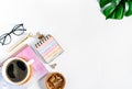 Flat lay of white working table place background with cup of coffee putting on it. Top view glasses, leaf, golden paper Royalty Free Stock Photo