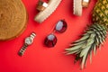 Flat lay, Wicker fashion bag, sunglasses, tropical pineapple and expensive watches and women`s shoes. Summer fashion, the concept