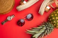 Flat lay, Wicker fashion bag, sunglasses, tropical pineapple and expensive watches and women`s shoes. Summer fashion, the concept