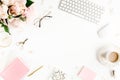 Flat lay women`s office desk. Female workspace with computer, pink peonies bouquet, accessories on white background. Top Royalty Free Stock Photo