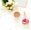 Flat lay women`s office desk. Female workspace with laptop,  flowers pink ranunkulus Royalty Free Stock Photo