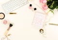 Flat lay women`s office desk workplace with flowers.