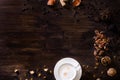 Flat lay wooden background dark brown wood. A cappuccino cup, sprinkled sugar, nuts