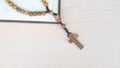 Flat lay of wooden cross and bible