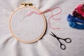 Flat lay with wooden embroidery hoops on a canvas background. Top view