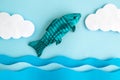 Flat lay of wooden fish with water and clouds made of paper abstract Royalty Free Stock Photo