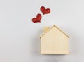 flat lay of wooden model house with red glitter hearts isolated on white background. dream house , home of love, strong Royalty Free Stock Photo