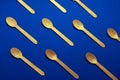 Flat lay wooden spoons pattern on a blue background