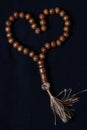 Flat Lay Wooden Tasbih, Love Shape Islam People prayer bead at Black Background