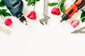 Flat Lay of Working construction tools and roses on grunge white
