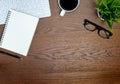 Flat lay, Workspace office desk table. View from above with keyboard, pen and notebooks, eyeglasses and cup of black coffee on bro Royalty Free Stock Photo