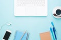 Flat lay of workspace with white laptop computer, smartphone, coffee and stationeries Royalty Free Stock Photo