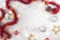 Flat lay xmas composition with empty space. Red tinsel, golden stars and silver Christmas balls Royalty Free Stock Photo