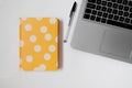 Flat lay of a yellow journal and laptop, startup business
