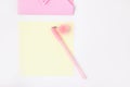 Flat lay: yellow paper, pink envelope with rhinestones, pen with pompom. Making postcard in envelope for Valentine`s Day. Do it