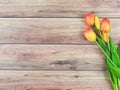 flat lay of yellow red tulip flowers on wooden table background with copy space for text. Feminine concept Royalty Free Stock Photo