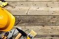 Flat lay yellow safety helmet with construction tools on wooden background. Happy Labor day concept. American national holiday Royalty Free Stock Photo