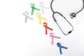 Flat layout of colorful ribbons beside a stethoscope