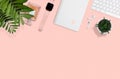 Flat layout of women workplace on pink background