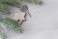 Flat layout on wooden background: figures, house, key and spruce branches / real estate 2020