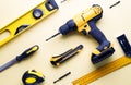 Flat layout of yellow hand tools on a yellow background. Royalty Free Stock Photo