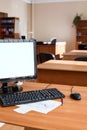 Flat lcd pc computer monitor with white isolated screen, empty office room Royalty Free Stock Photo