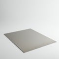 A flat, metallic sheet rests on a plain white surface. The sheet is rectangular with Royalty Free Stock Photo