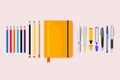 Flat notebook with colorful pencils and pens Royalty Free Stock Photo