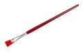 Flat paint brush with red tip and brown handle