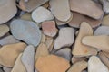 Flat pebble textured natural stone background, top view. Flat stones are used in garden or beach decoration