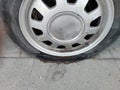Flat punctured car wheel after an accident close-up Royalty Free Stock Photo
