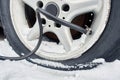 Flat rim. tire puncture. pump pumps air into the tire in winter Royalty Free Stock Photo