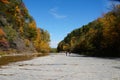 The flat rock and river bed at Taughannock Falls with the background of fall foliage in Upstate New York, U.S.A Royalty Free Stock Photo