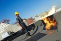 Flat roof covering repair works with roofing felt Royalty Free Stock Photo