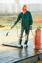 Flat roof covering repair works with roofing felt Royalty Free Stock Photo