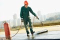 Flat roof covering repair works with roofing felt Royalty Free Stock Photo