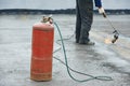 Flat roof covering repair works with roofing felt Royalty Free Stock Photo