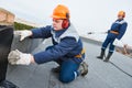 Flat roof installation. Heating and melting bitumen roofing felt Royalty Free Stock Photo