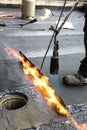 Flat roof installation. Heating and melting bitumen roofing felt Royalty Free Stock Photo